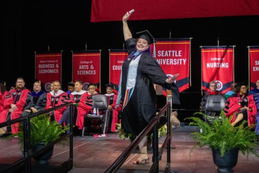 A student with degree in hand happy dancing