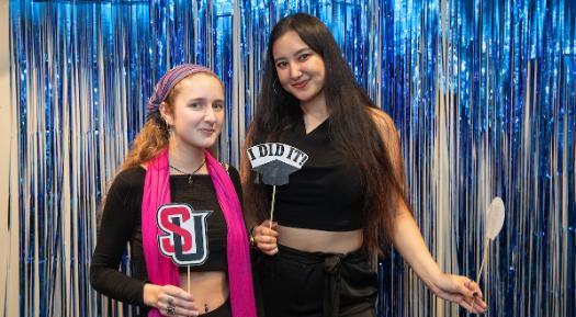 Two students posting at ISC graduation ceremony