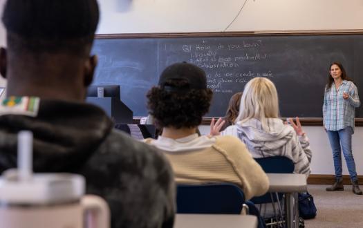 teacher in front of chalkboard on first day